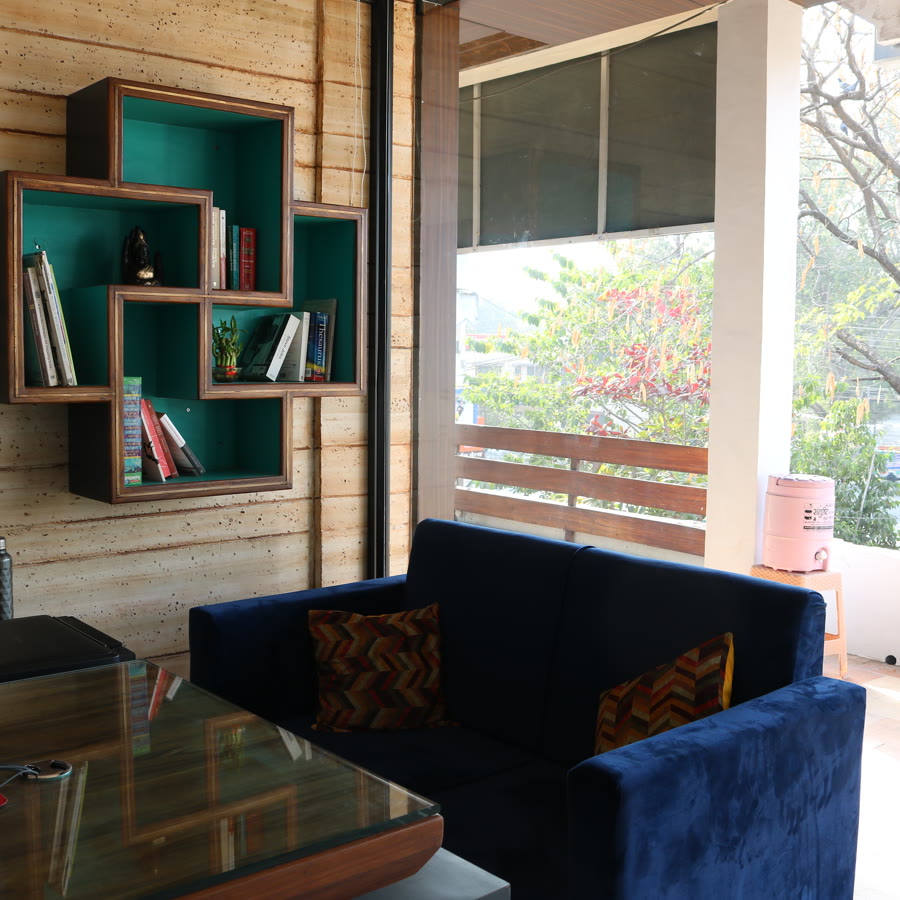 Creative Spaces studio interior — bookshelf and lounge seating by the balcony